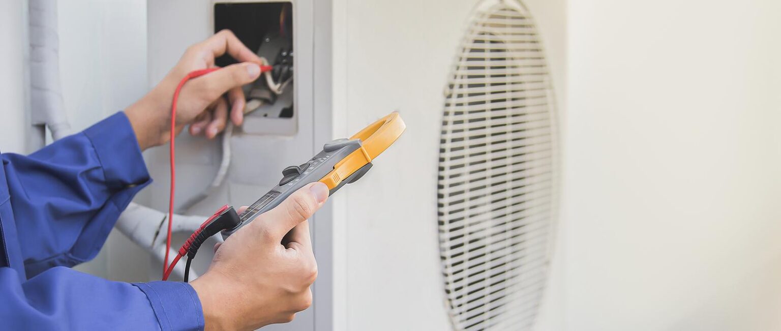 HVAC technician using a Gauge to check Refrigerant Levels in an Air Conditioner in Lake Forest, IL