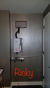 Aprilaire Model 800 Humidifier Mounted in a Residential Hallway