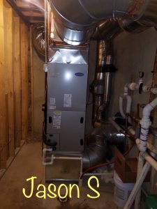 Water Heaters Connected By Pipes In A Laundry Room